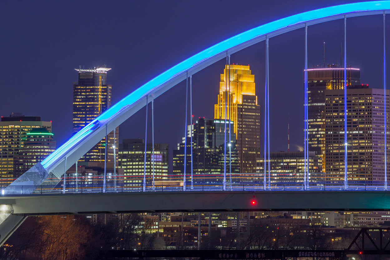 Minneapolis skyline at night showcasing the Lowry bridge